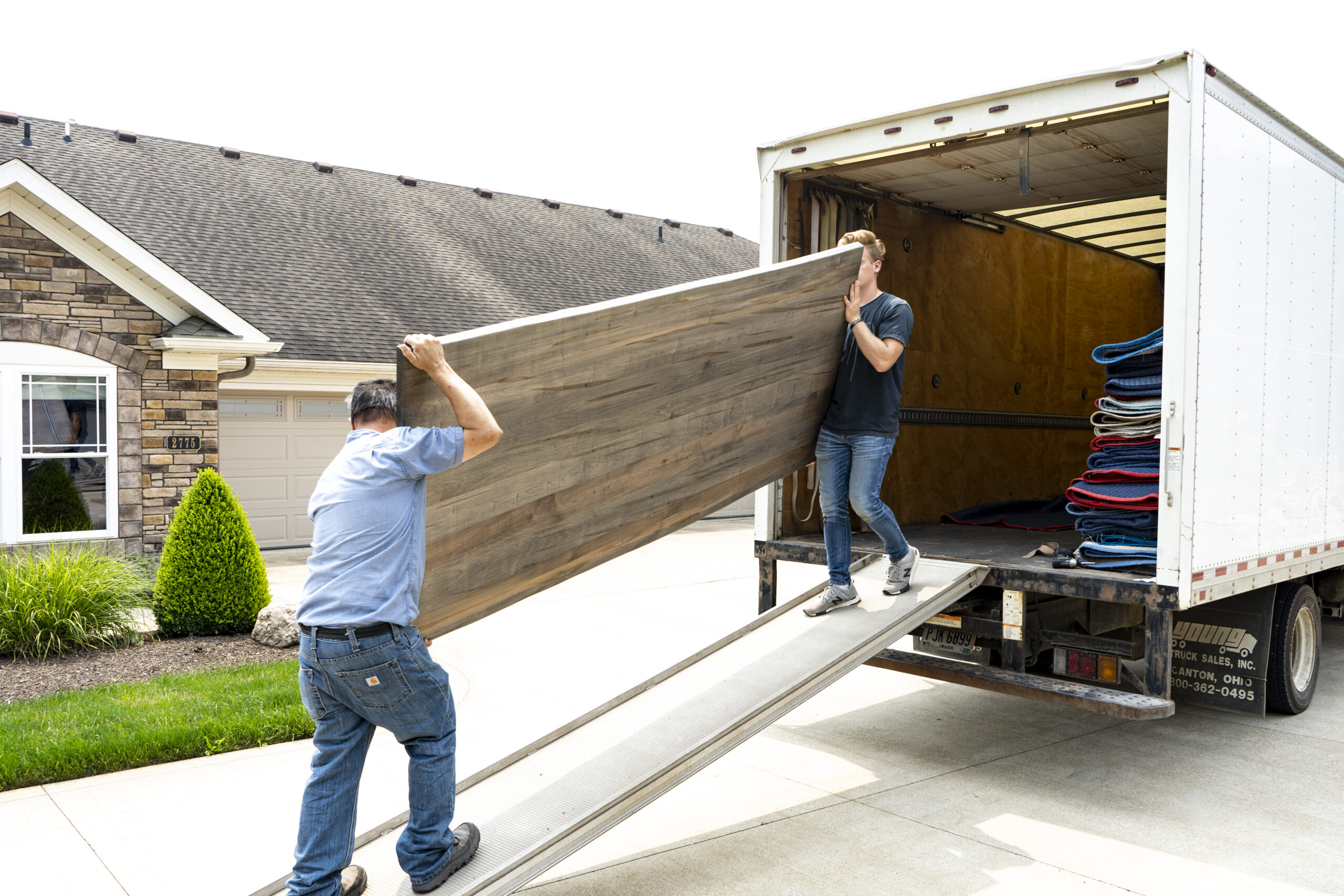 Jake’s furniture delivery team carefully moving handcrafted furniture